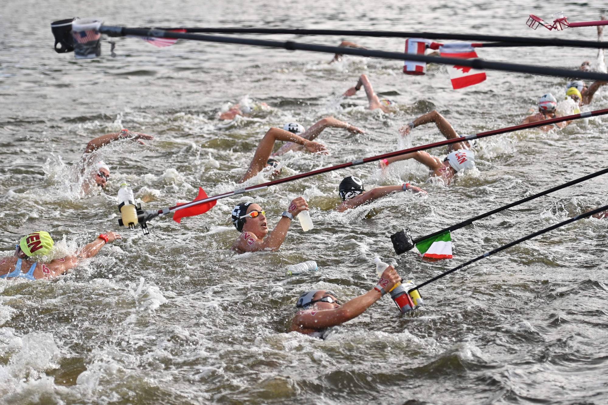 Swimmers at a feed station along the course during the women's 10-km marathon swimming event | AFP-JIJI