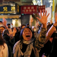 Protesters sing outside Polytechnic University while police keep it under siege in in November 2019. | REUTERS 