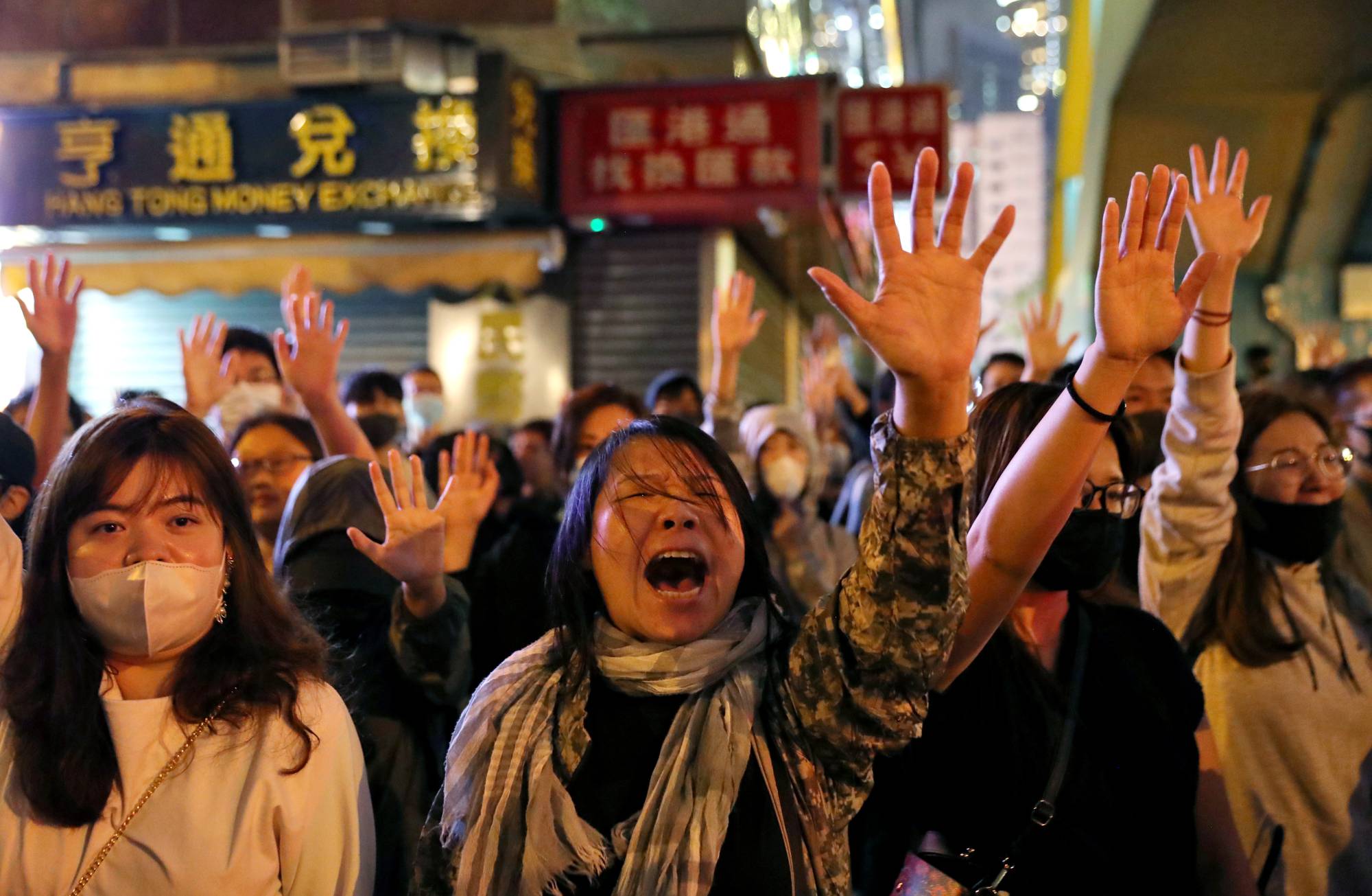 Protesters sing outside Polytechnic University while police keep it under siege in in November 2019. | Reuters 