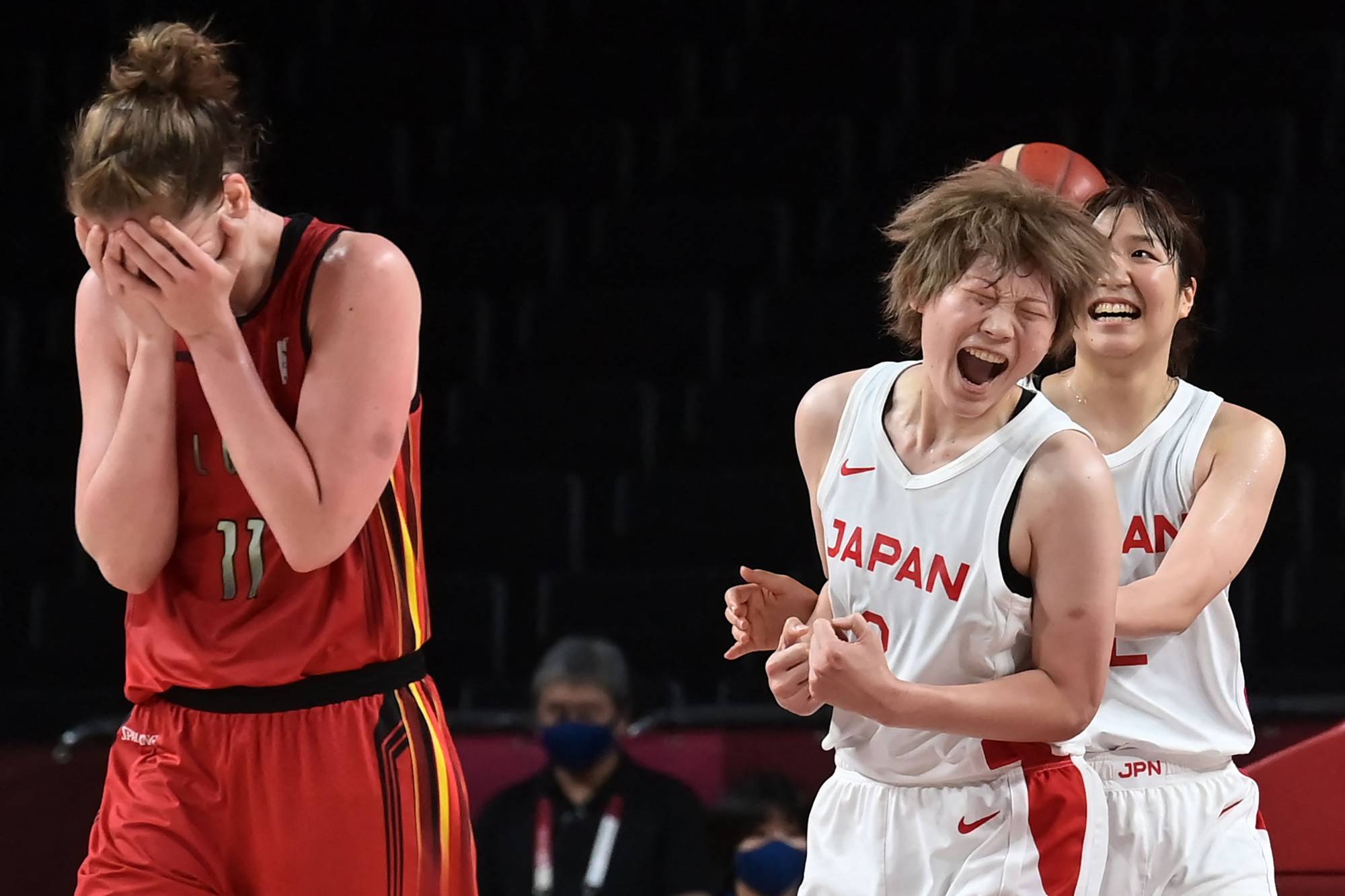Japan's Maki Takada (center) and Yuki Miyazawa celebrate after the Akatsuki Five topped Belgium in the women's quarterfinals. | AFP-JIJI