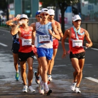 Massimo Stano of Italy (front) and Japan\'s Toshikazu Yamanishi (right) and Koki Ikeda compete in the men\'s 20-kilometer race walk on Thursday in Sapporo.  | REUTERS