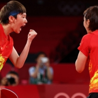 Chen Meng and Wang Manyu of China celebrate after winning their match against Kasumi Ishikawa and Miu Hirano in the final of the women\'s table tennis team event.  | REUTERS