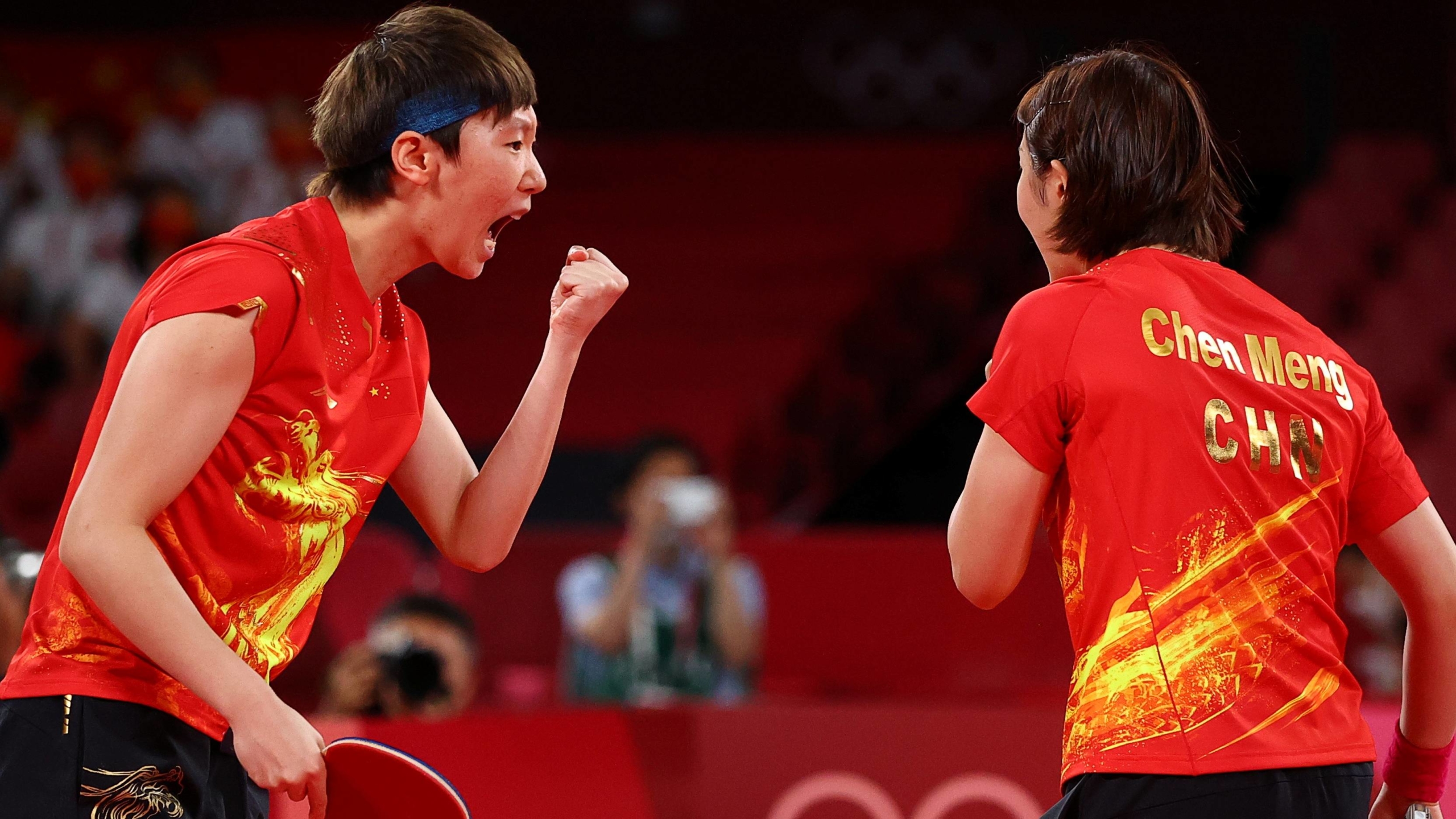 Chen Meng and Wang Manyu of China celebrate after winning their match against Kasumi Ishikawa and Miu Hirano in the final of the women's table tennis team event. | REUTERS