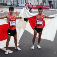 Silver medalist Koki Ikeda and bronze medalist Toshikazu Yamanishi celebrate after the men\'s 20-kilometer race walk in Sapporo.  | REUTERS 