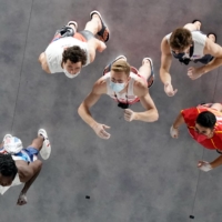 Athletes observe the wall before competing in the men\'s sport climbing lead final  | AFP-JIJI