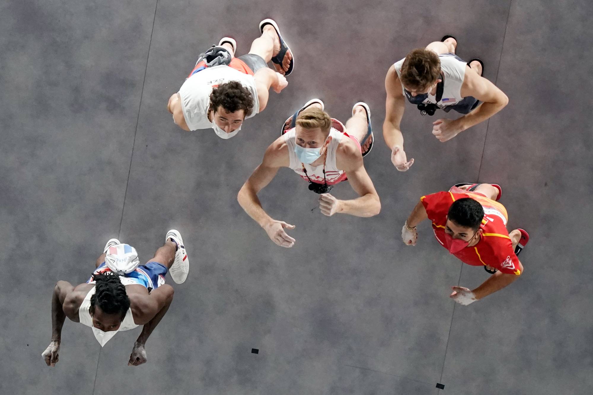 Athletes observe the wall before competing in the men's sport climbing lead final | AFP-JIJI