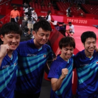 Jun Mizutani, Koki Niwa and Tomokazu Harimoto, along with coach Yosuke Kurashima, celebrate winning bronze in the men\'s team table tennis event.  | REUTERS