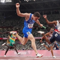 Italy\'s Filippo Tortu (wearing No. 8) crosses the finish line first to secure the gold medal for his nation in the men\'s 4x100-meter final at National Stadium on Friday.  | REUTERS