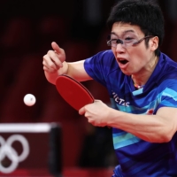 Japan\'s Jun Mizutani in action against South Korea\'s Jang Woojin in the bronze medal match of the men\'s team event. | REUTERS
