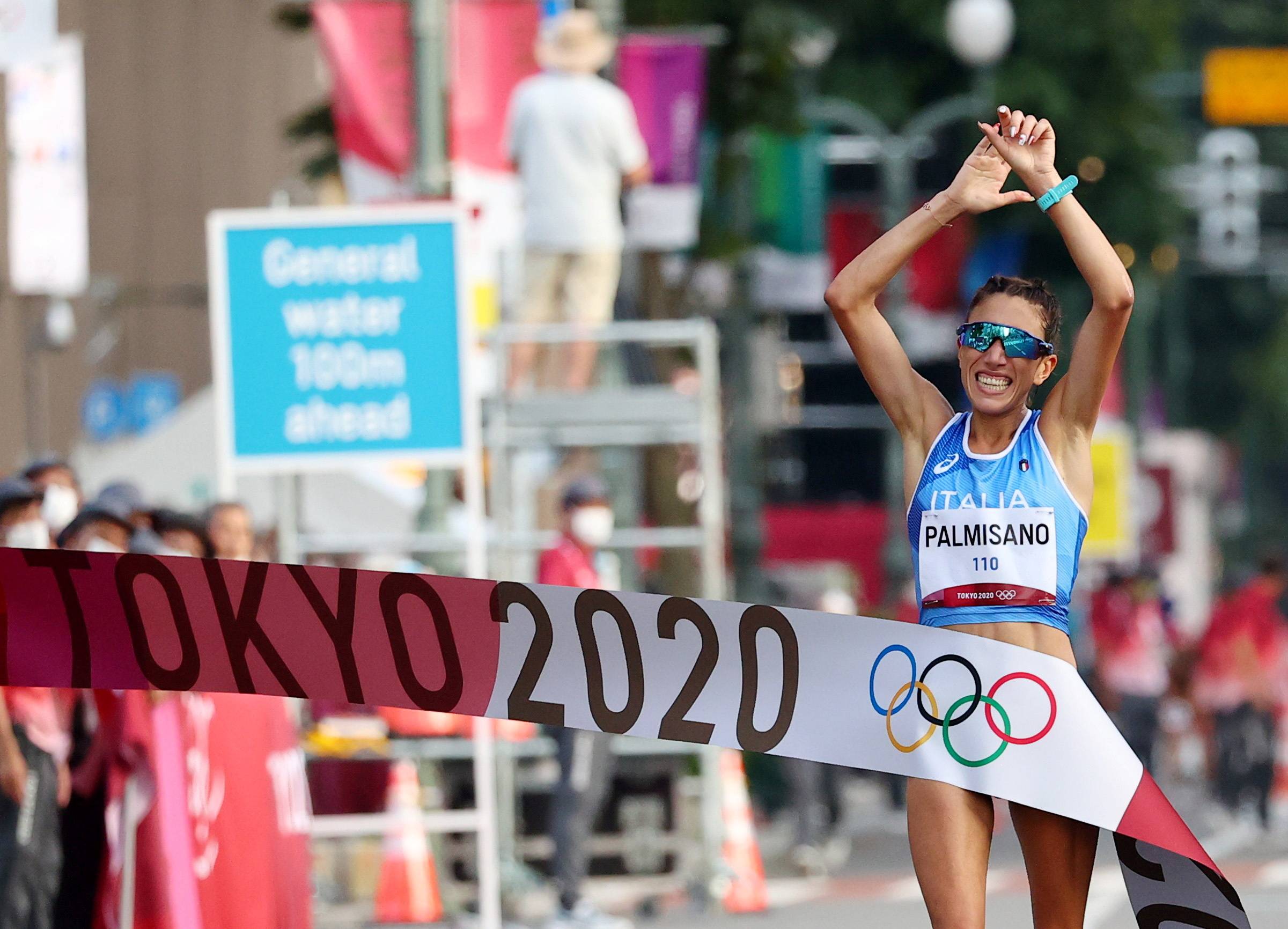 Italy's Antonella Palmisano celebrates crossing the finish line to win gold. | REUTERS