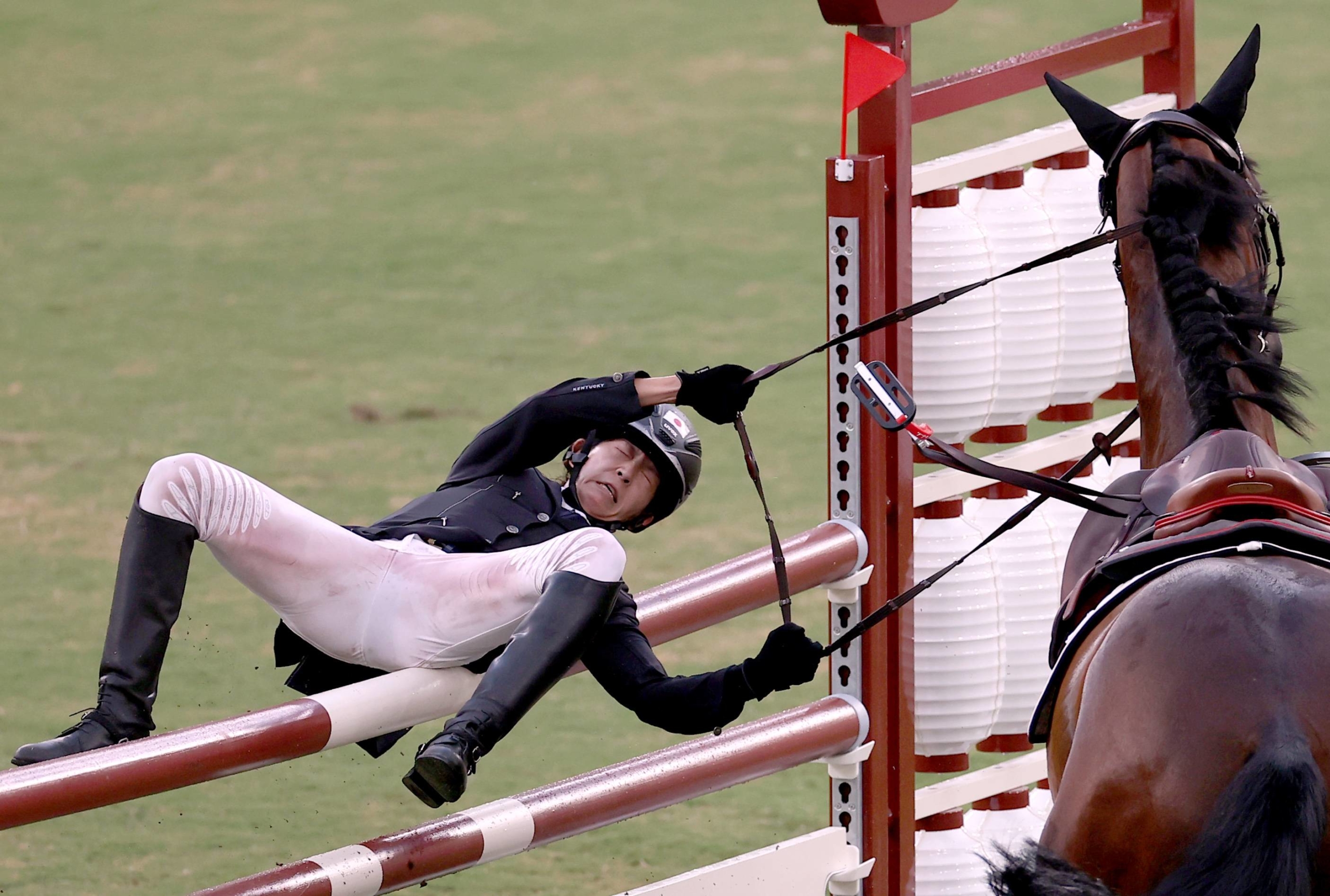 Japan's Natsumi Takamiya falls from her horse the women's riding segment of the modern pentathlon. | REUTERS