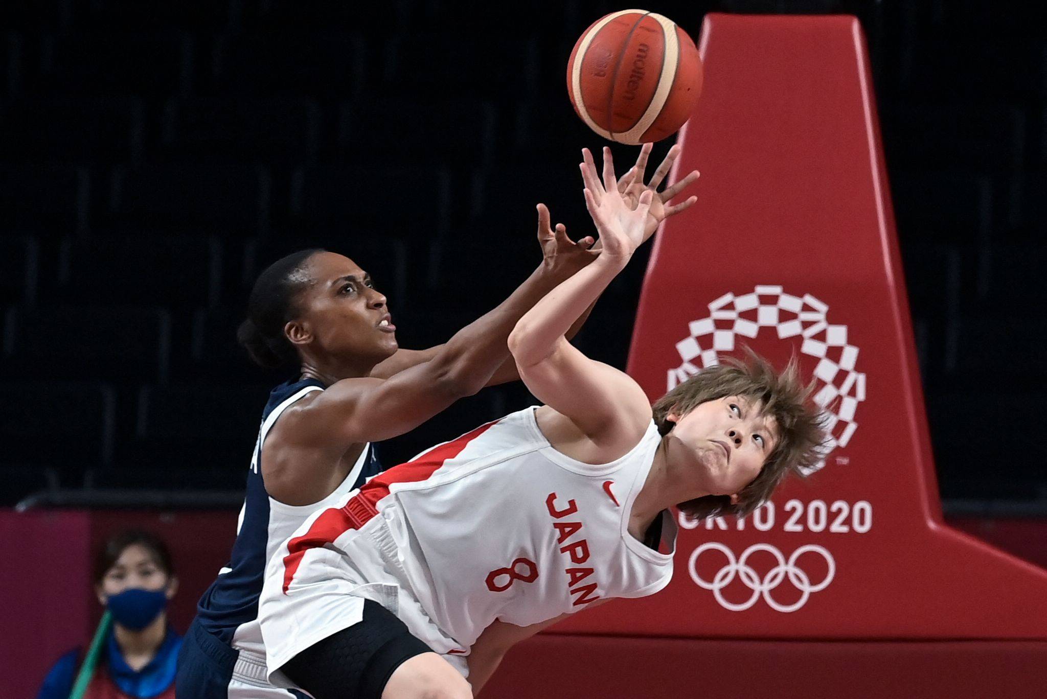 France's Sandrine Gruda and Japan's Maki Takada fight for the ball in the women's semi-final basketball match in Saitama. | AFP-JIJI
