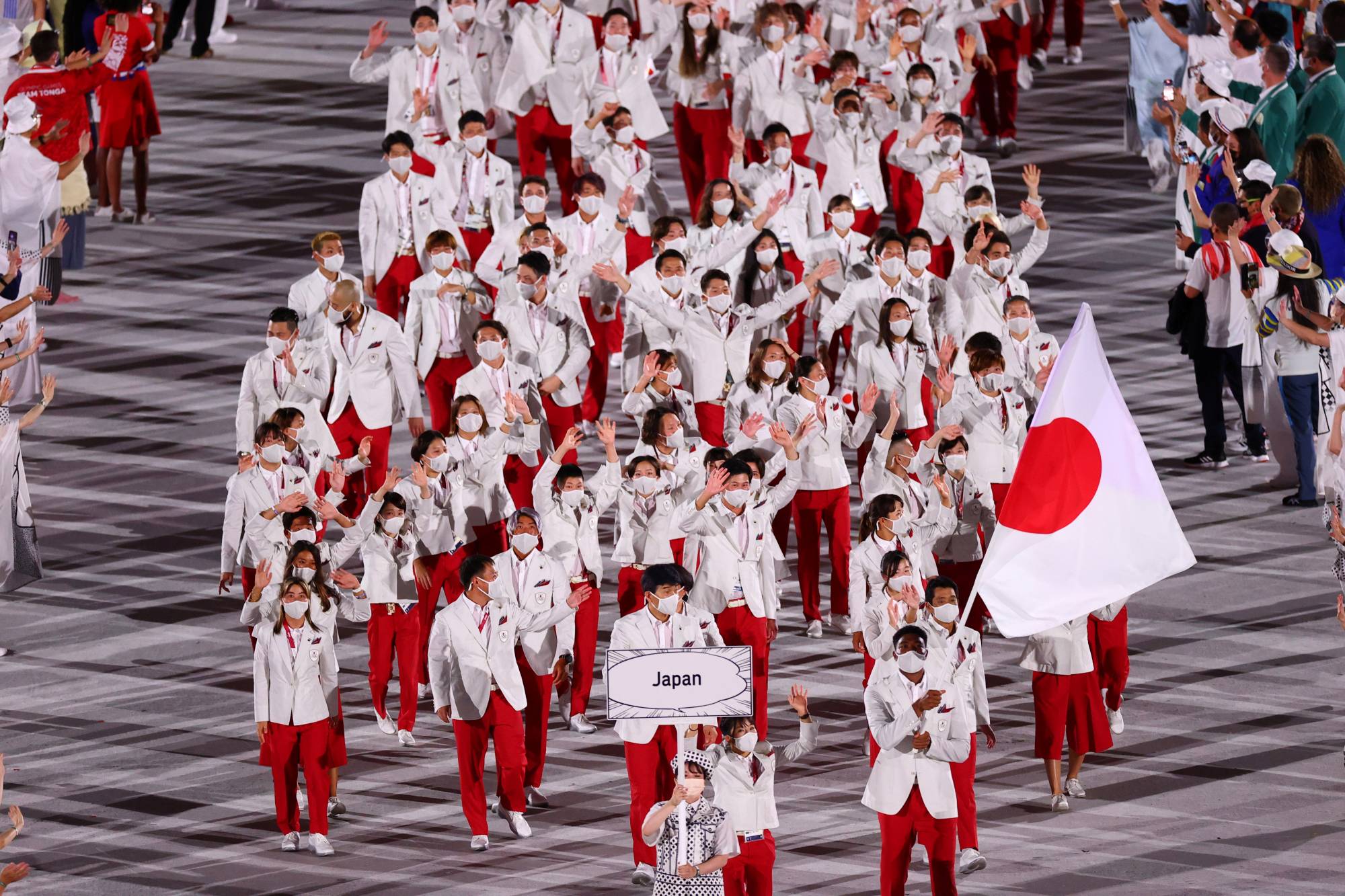 Members of Japan's Olympic delegation walk into the National Stadium during the opening ceremony of the Tokyo Games on July 23. | REUTERS