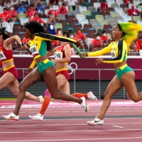 A baton pass during the women\'s 4 x 100-meter relay | REUTERS