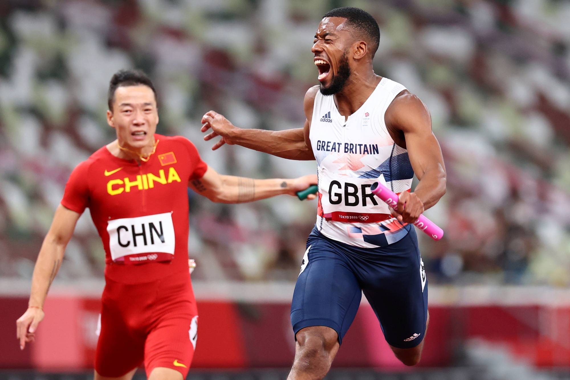 Britain'sb Nethaneel Mitchell-Blake crosses the finish line in second place in the men's 4 x 100-meter relay. | REUTERS
