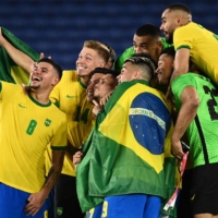 Players of Brazil pose for a selfie as they celebrate after winning the men\'s gold medal soccer match by defeating Spain 2-1 in extra time at Yokohama International Stadium on Saturday night. | AFP-JIJI