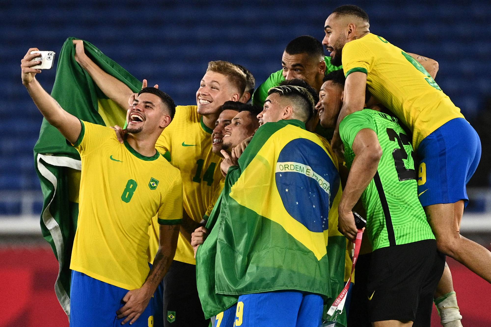 Players of Brazil pose for a selfie as they celebrate after winning the men's gold medal soccer match by defeating Spain 2-1 in extra time at Yokohama International Stadium on Saturday night. | AFP-JIJI