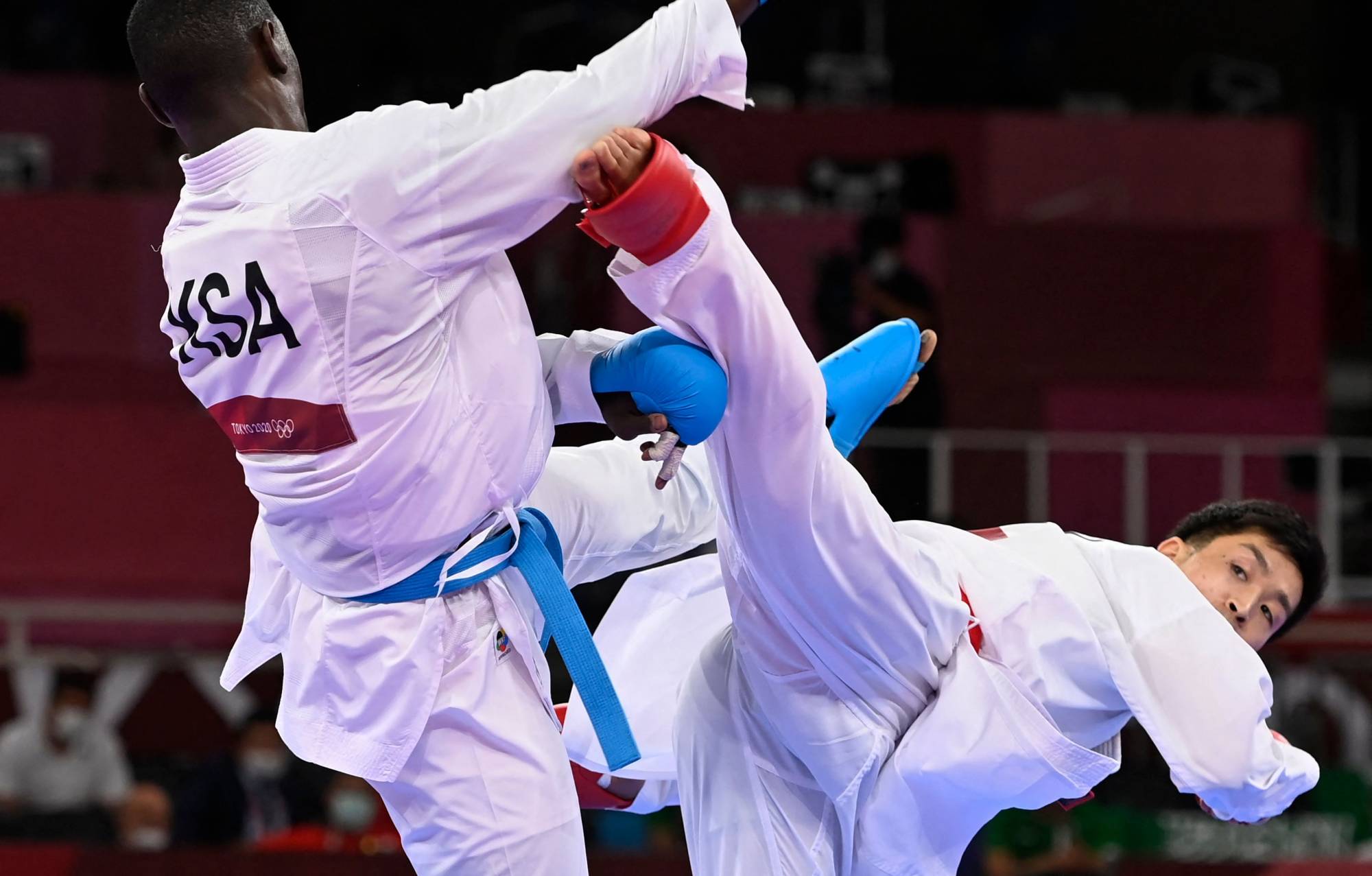 Saudi Arabia's Tareg Hamedi (left) competes against Japan's Ryutaro Araga in the men's kumite over-75 kg semifinal on Saturday at Nippon Budokan. | AFP-JIJI