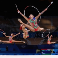 Team Japan in action with clubs and hoops during qualification for the group all-around qualification gymnastic competition. | REUTERS