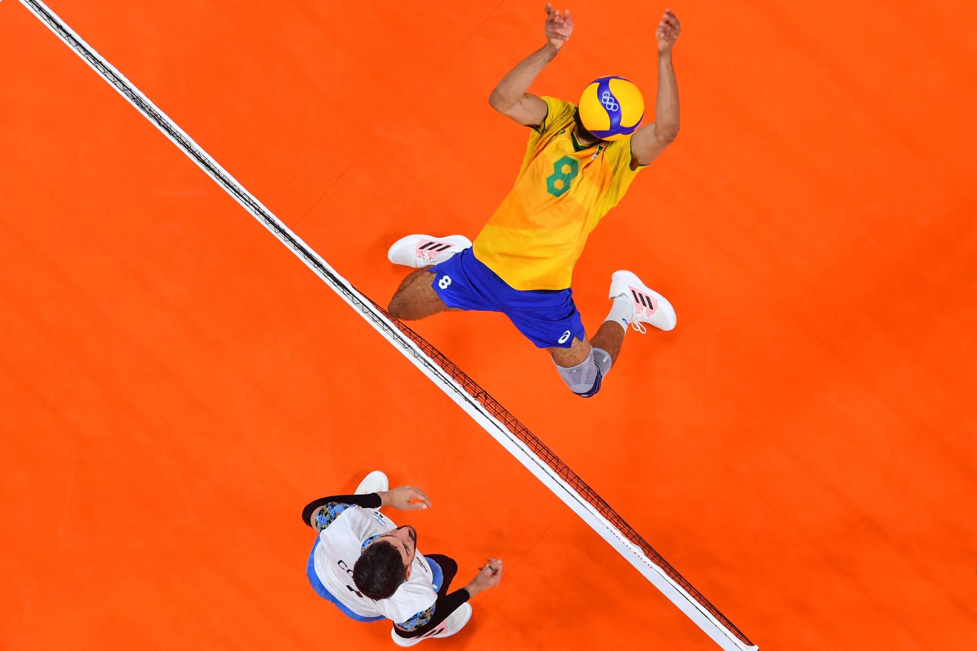 Brazil's Wallace de Souza (right) attempts to block a shot in the men's bronze medal volleyball match between Argentina and Brazil. | AFP-JIJI