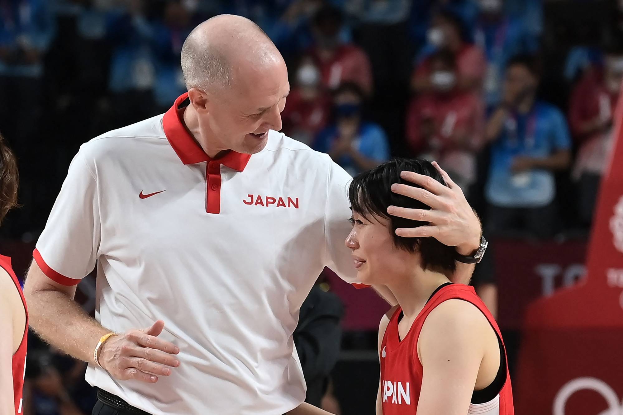 Japan women's basketball coach Thomas Hovasse (left) comforts Nako Motohashi after their defeat in the women's final. | AFP-JIJI