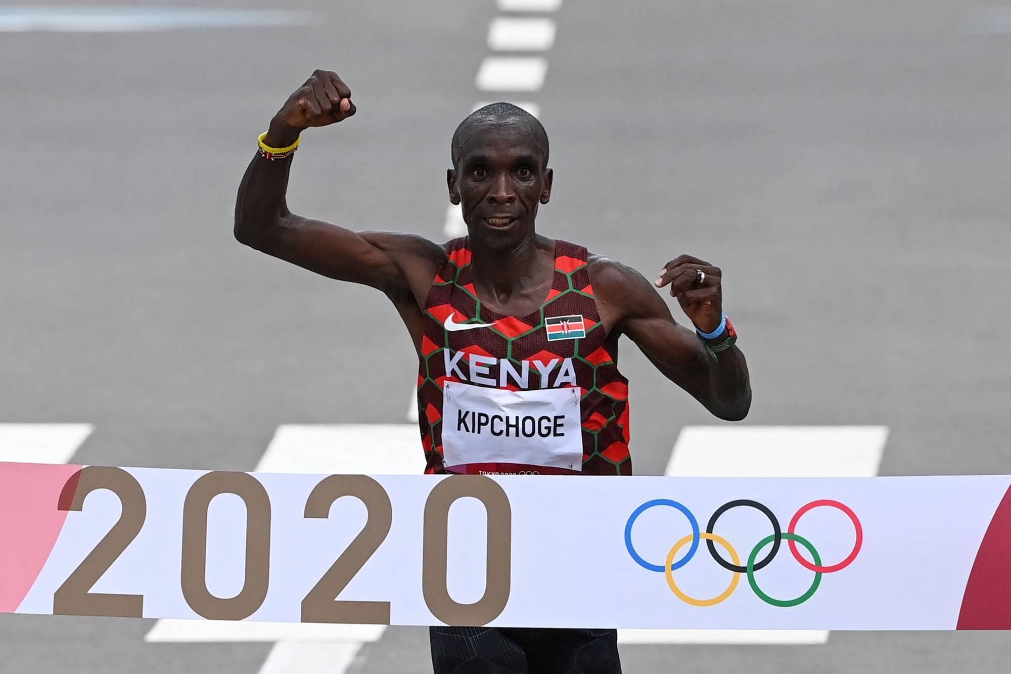 Kenya's Eliud Kipchoge crosses in finish line to first place in the men's Olympic marathon final in Sapporo on Sunday. | AFP-JIJI