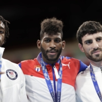 Gold medlist Andy Cruz of Cuba, silver medalist Keyshawn Davis of the U.S., and bronze medalist Hovhannes Bachkov of Armenia at the victory ceremony for the men\'s lightweight boxing.  | REUTERS