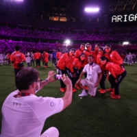 Japanese athletes pose as a thank you message is displayed inside the stadium during the closing ceremony  | POOL VIA REUTERS