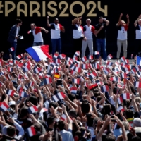 People gather at Paris\' Olympics fan zone to watch the closing ceremony of the Tokyo Games, in front of the Eiffel Tower, at Trocadero Gardens in Paris. | REUTERS