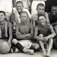 Shunji Okada (back row, second from right) participates in a school soccer club practice as a former team member during the summer after he graduated from the Okayama second middle school in March 1942. | COURTESY OF MASAKATSU TAKEYARI
