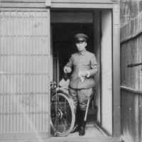 Motoichi Terao stands at the entrance of his home. He commuted to work at the Chugoku Military District Headquarters by bicycle every morning. | COURTESY OF OKIHARU TERAO
