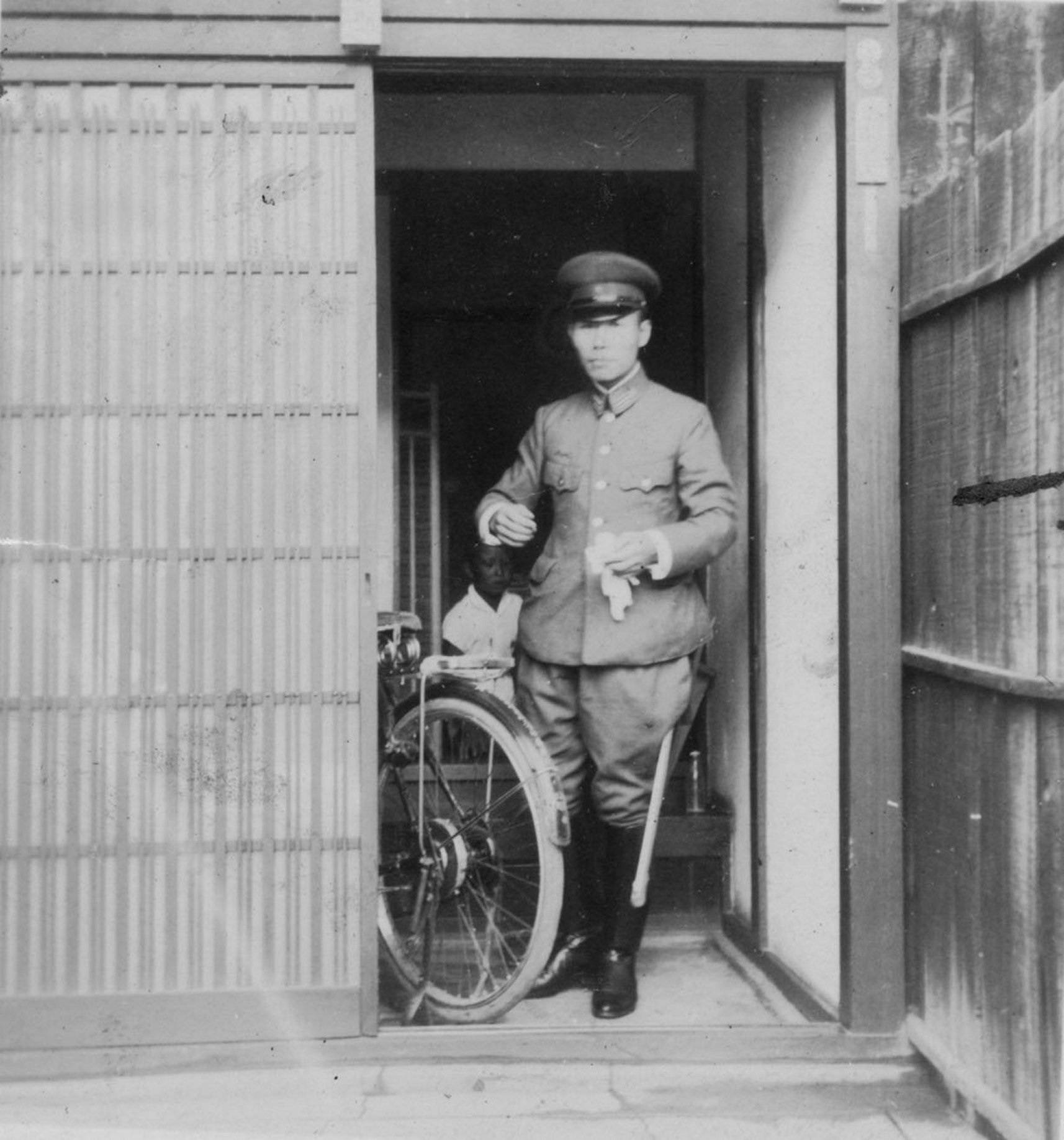 Motoichi Terao stands at the entrance of his home. He commuted to work at the Chugoku Military District Headquarters by bicycle every morning. | Courtesy of Okiharu Terao 