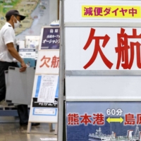 Signs give information about canceled ferries due to Tropical Storm Lupit at Kumamoto Port on Sunday evening.  | KODO