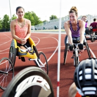 Hannah McFadden (left) and Tatyana McFadden, pictured in 2016, have provided support to visually impaired teammates on the U.S. Paralympic team. | DANIEL ACKER / THE NEW YORK TIMES