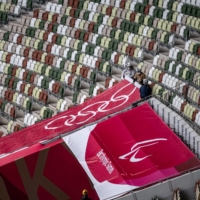 An Olympic Rings banner is unfurled next to one for the upcoming Paralympic Games at the Olympic Stadium in Tokyo on Monday. | AFP-JIJI