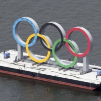 The giant floating Olympics rings monument set up at Odaiba Marine Park in Tokyo is removed Wednesday to be replaced with the symbol for the Paralympics. | KYODO