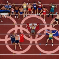 Decathlon athletes pose for a group photo after competing. With more competitors taking to social media to talk about their experience, some talked about previously taboo topics such as mental health.  | REUTERS