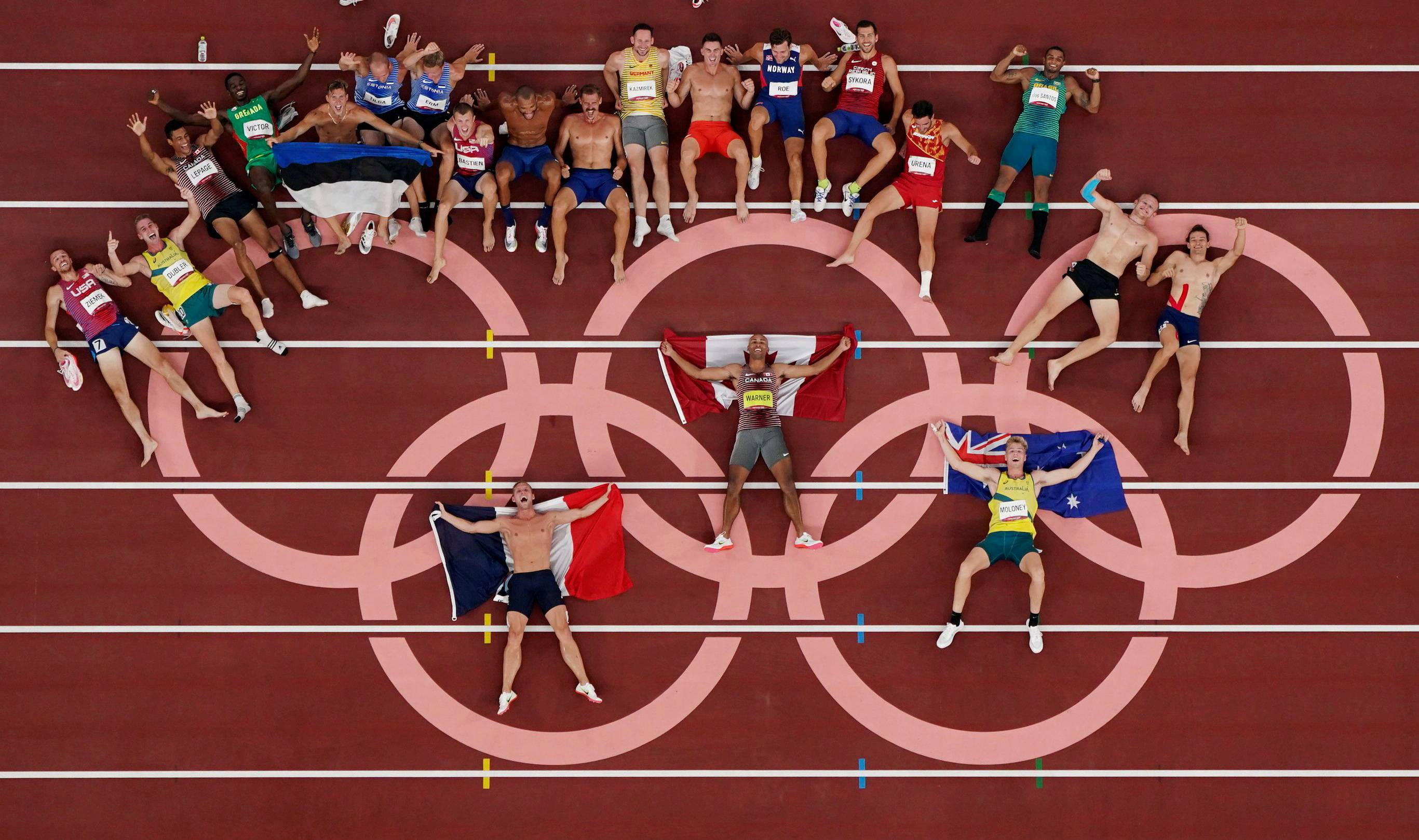 Decathlon athletes pose for a group photo after competing. With more competitors taking to social media to talk about their experience, some talked about previously taboo topics such as mental health. | REUTERS