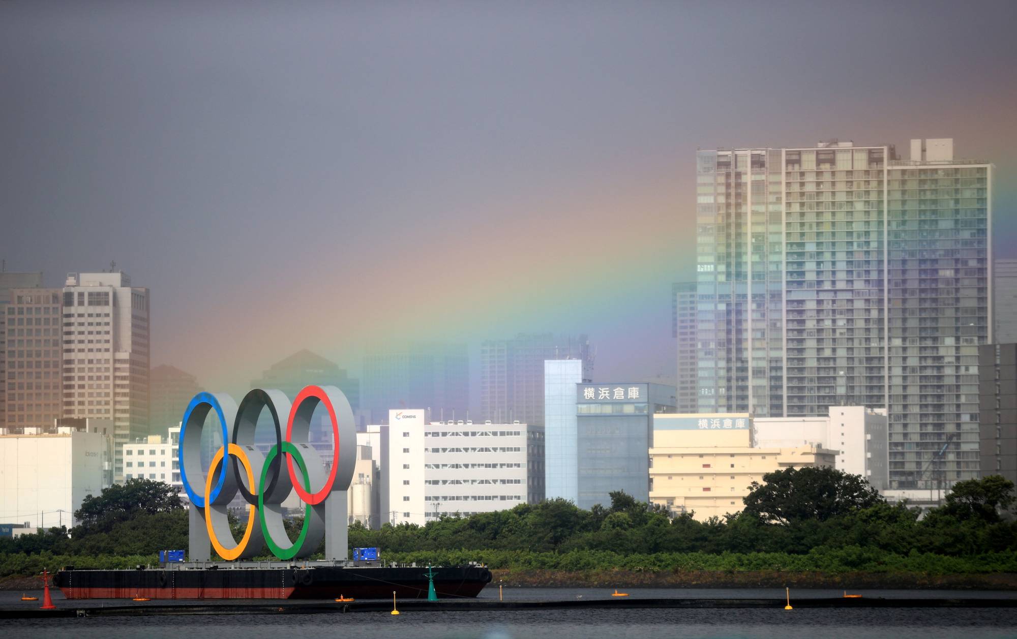 A rainbow appears over Tokyo during a women’s triathalon event in Odaiba Marine Park. Though it doesn’t look like the Olympics will provide the city with any sort of pot of gold, much of Japan was instead satisfied with the record number of gold medals that their country took home from this year’s Games. | REUTERS