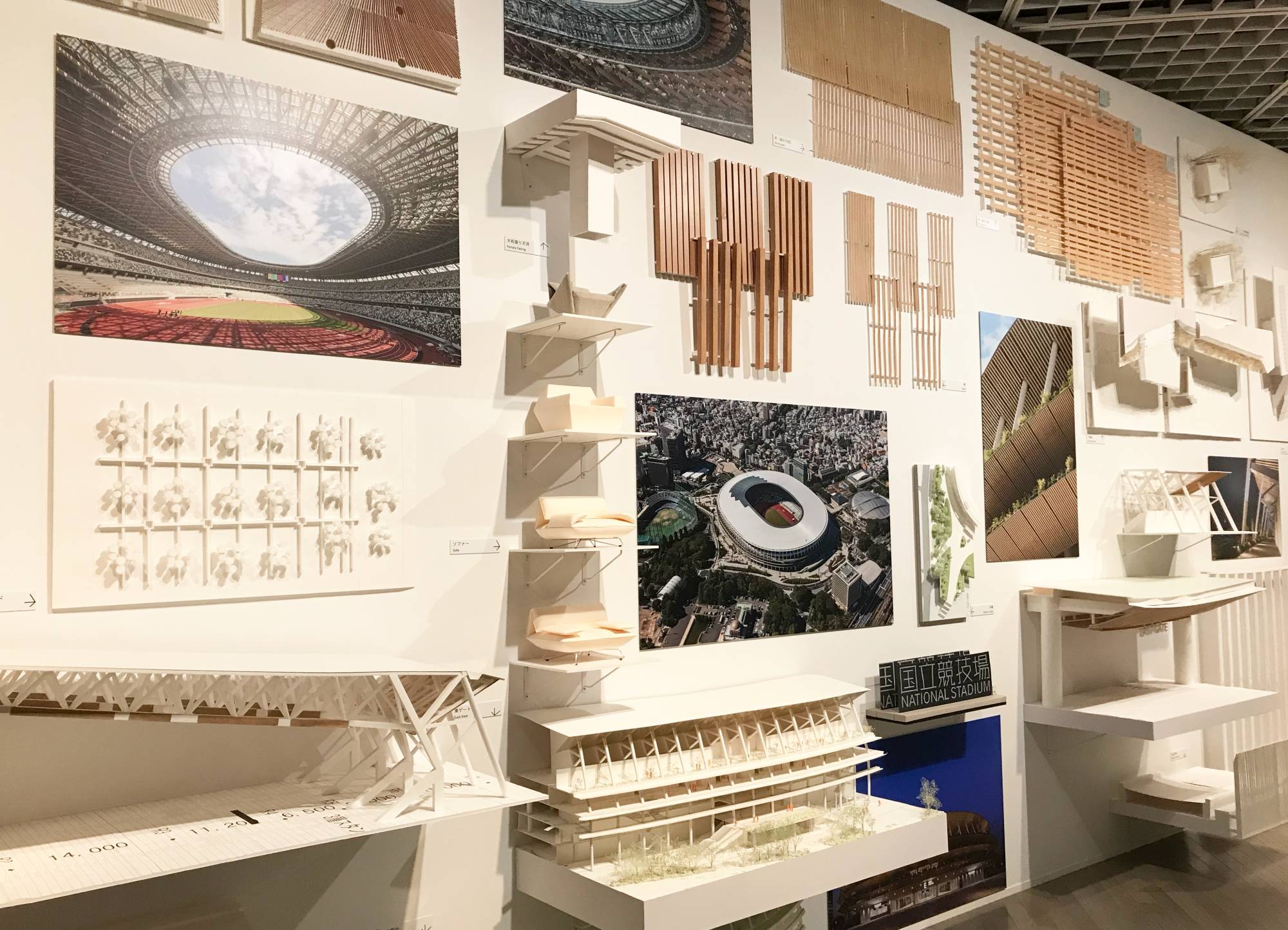 A wall of models and plans of Kengo Kuma’s National Stadium design greets visitors to 'Kuma Kengo: Five Purr-fect Points for a New Public Space,' the architect’s first major solo exhibition at The National Museum of Modern Art, Tokyo. | © MIO YAMADA 