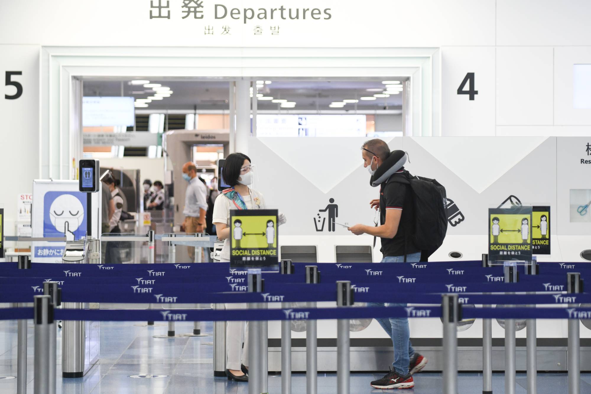 A traveler heads to the departure gates at Tokyo's Haneda Airport on Monday. | BLOOMBERG