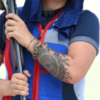 Tattoos on the arms of French skeet athlete Lucie Anastassiou | REUTERS