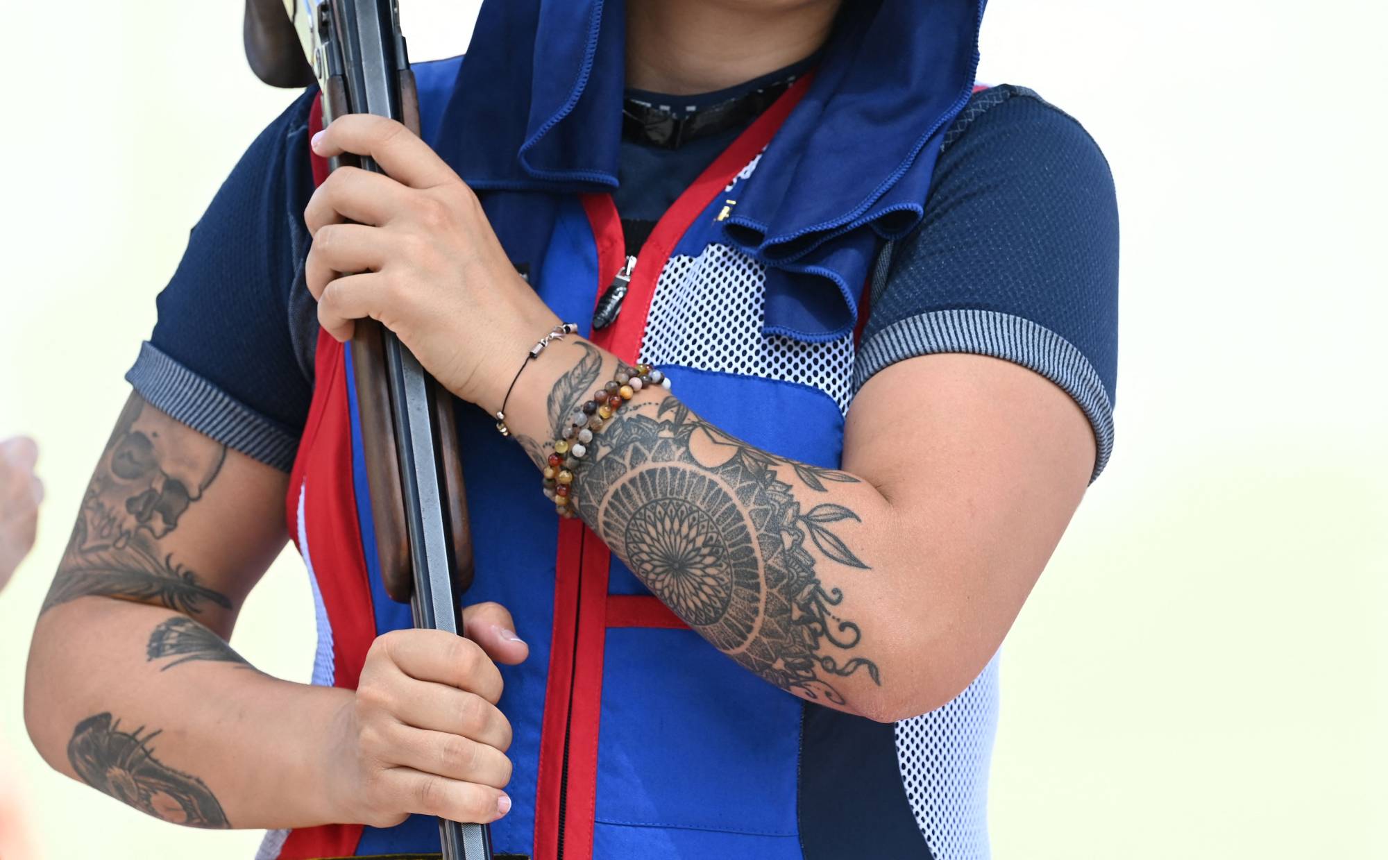 Tattoos on the arms of French skeet athlete Lucie Anastassiou