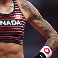 Tattoos on the arm of Canadian pole vaulter Anicka Newell | REUTERS