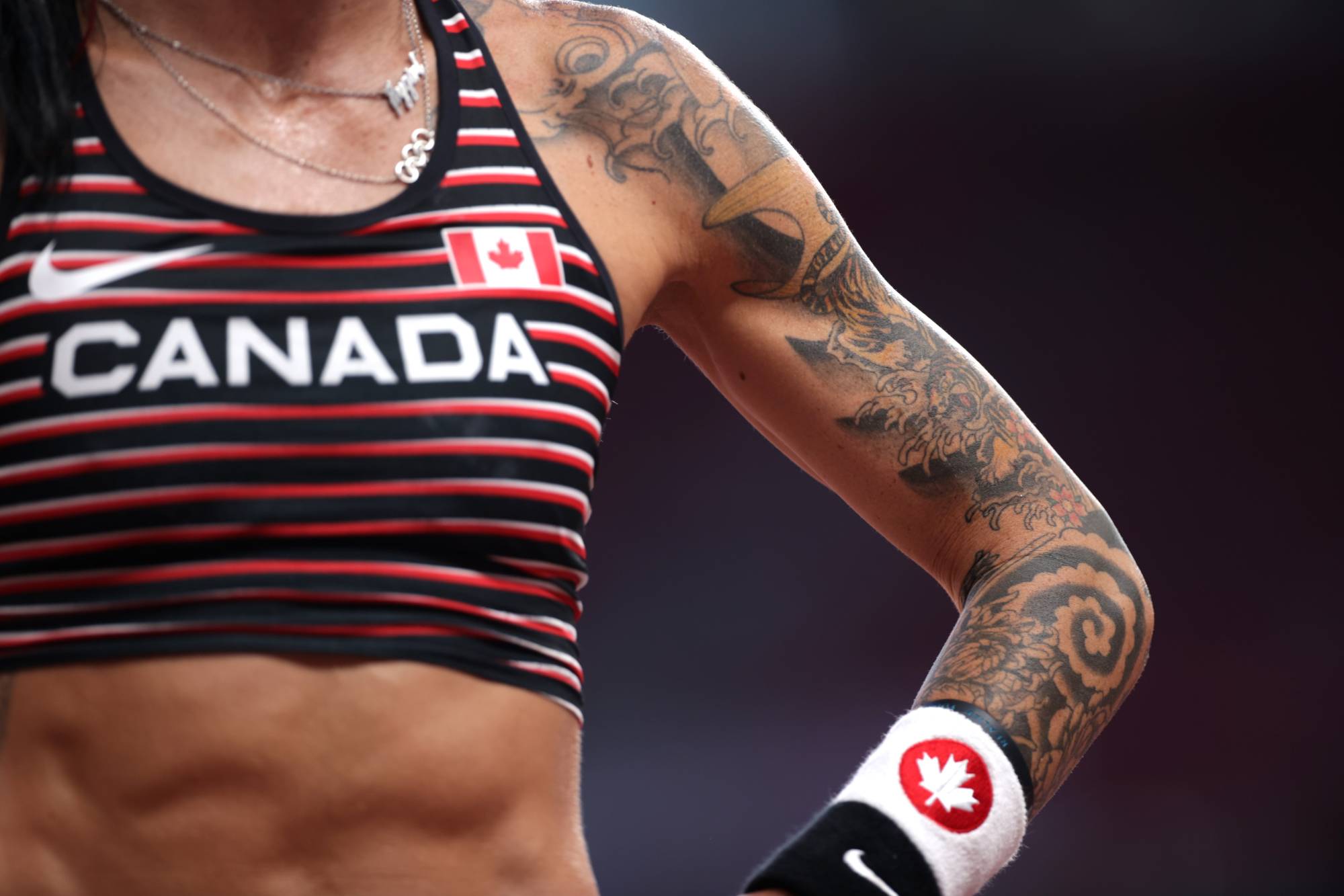 Tattoos on the arm of Canadian pole vaulter Anicka Newell | REUTERS