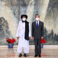 Chinese Foreign Minister Wang Yi meets with Mullah Abdul Ghani Baradar, political chief of Afghanistan\'s Taliban, in Tianjin, China, on July 28.  | XINHUA / VIA REUTERS