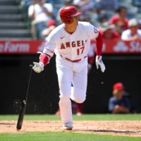 Angels designated hitter Shohei Ohtani singles in the fifth inning against the Houston Astros at Angel Stadium in Anaheim, California, on Sunday. | USA TODAY / VIA REUTERS