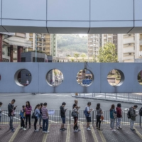 Voters wait in line at a polling station in Hong Kong in November 2019. When Hong Kong’s pro-democracy politicians won a resounding victory in local council elections in 2019, they inspired hopes of democratic change. Now, fears of arrest have driven most of them to quit, laying bare that dream’s dramatic collapse.  | LAM YIK FEI/THE NEW YORK TIMES