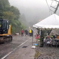 Rescue workers temporarily suspended their search operations due to fears of a secondary mudslide in Unzen, Nagasaki Prefecture, on Tuesday. | CITY OF UNZEN / VIA KYODO