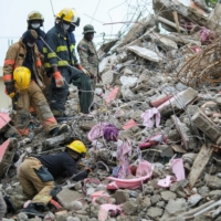Haitian firefighters search for survivors under the rubble of a destroyed building after Saturday\'s 7.2 magnitude quake in Les Cayes, Haiti. | REUTERS